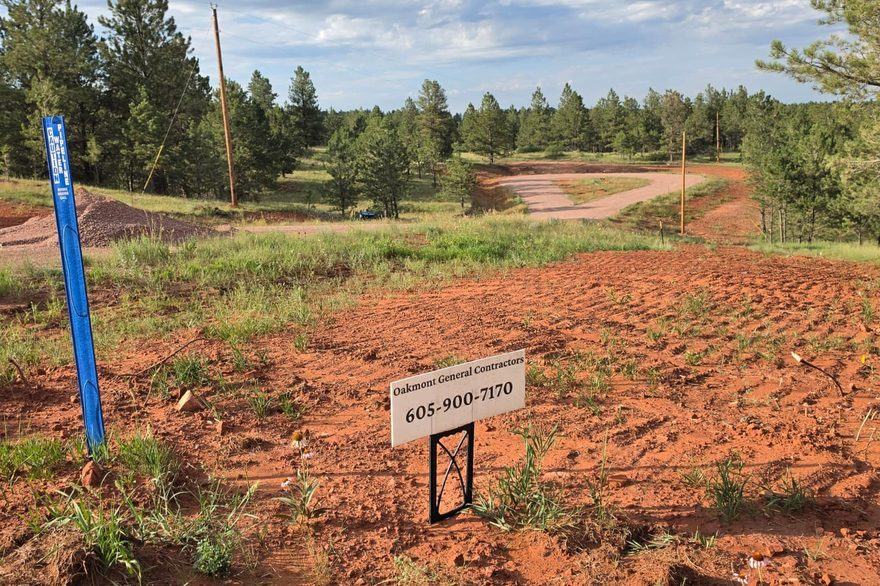 Oakmont General Contractors job sign staked on a graded build site