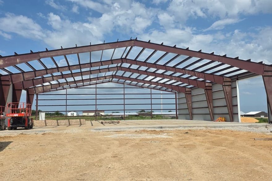 Oakmont clear-span steel frame standing on a prepared building pad